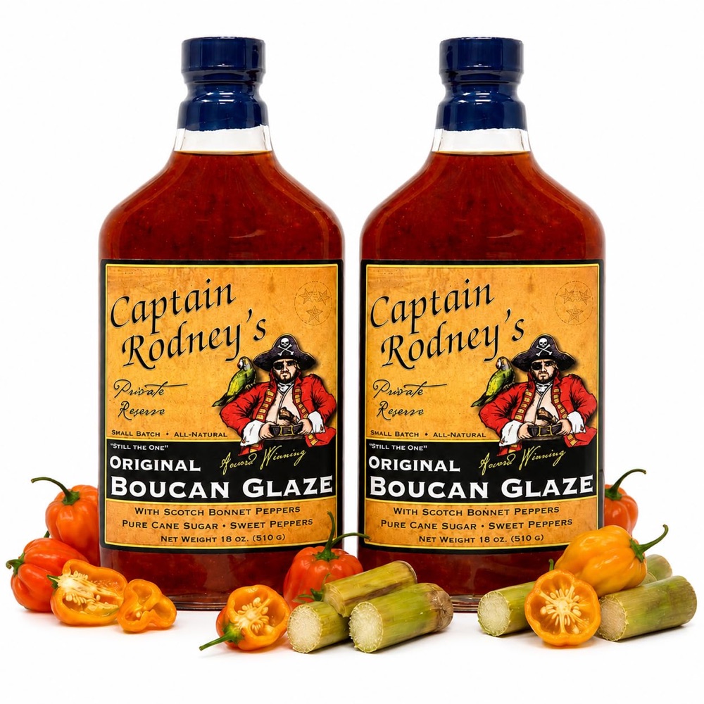 The rebuilt Captain Rodney's Boucan Glaze listing image: two full-size bottles at high resolution with scotch bonnet peppers and sugar cane arranged at the base